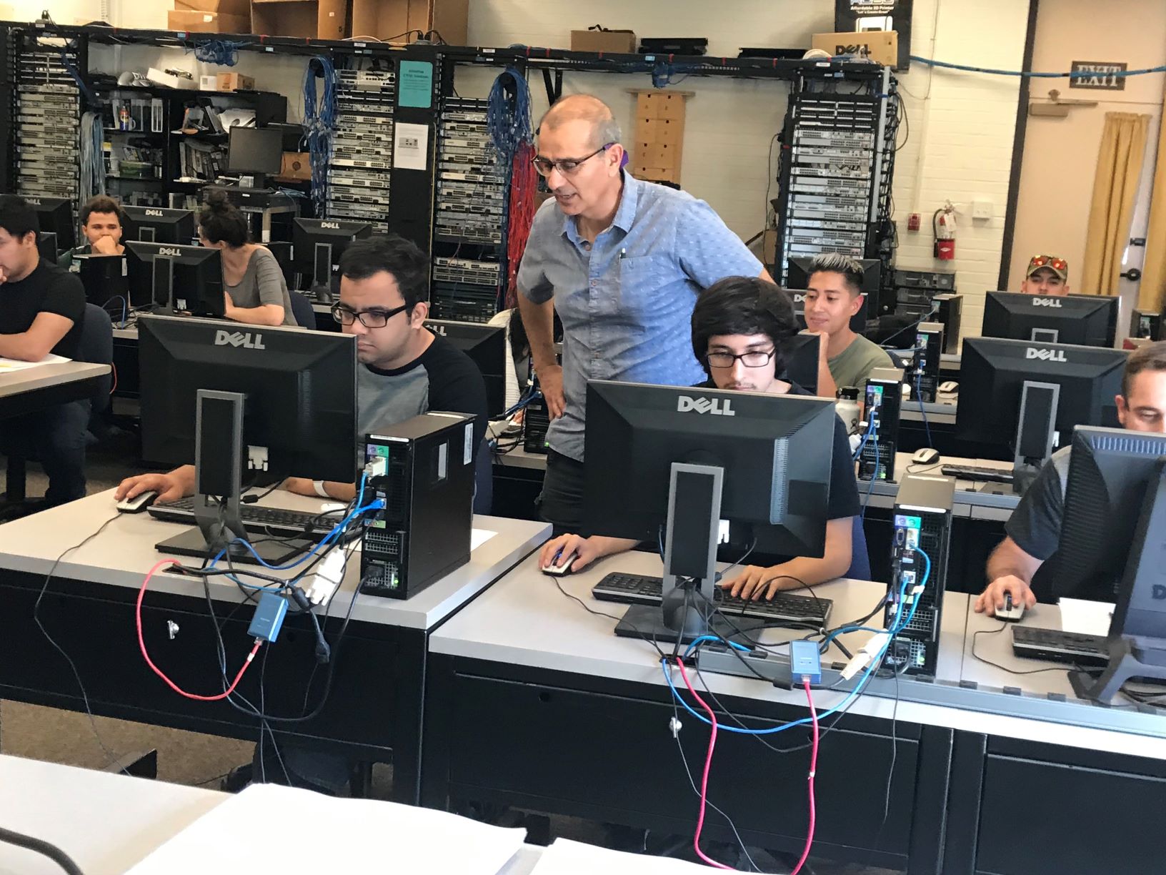 computer networking class at moorpark college. the instructor is helping students at their computers